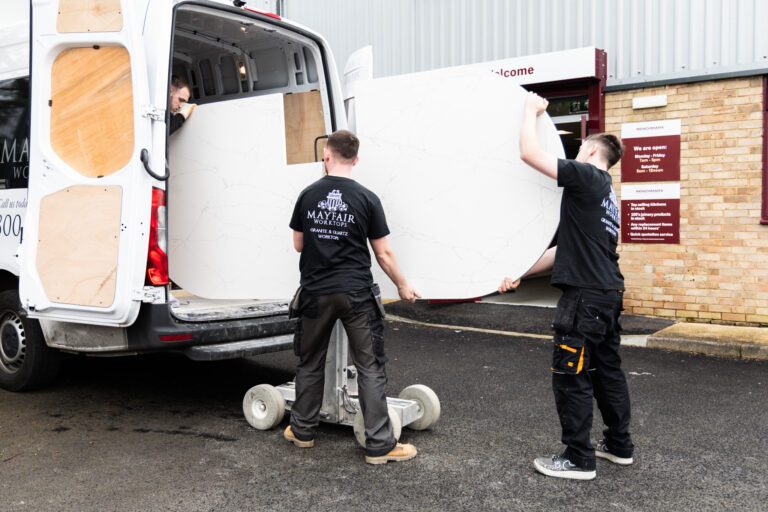 Mayfair Worktops Stonemasons unloading a White Macaubus Quartz worktop slab from a van using a trolley