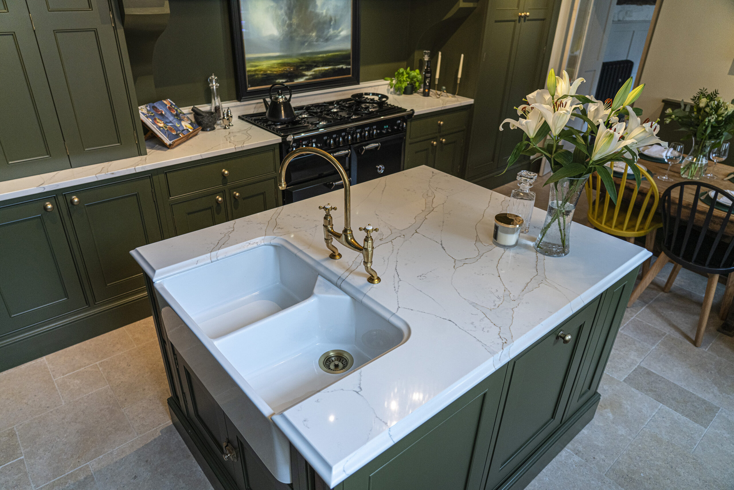 Gold Calacatta kitchen island with sink, brass tap and warm veining