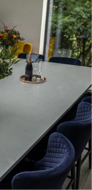Carrara Quartz worktop beside large window with flower vase