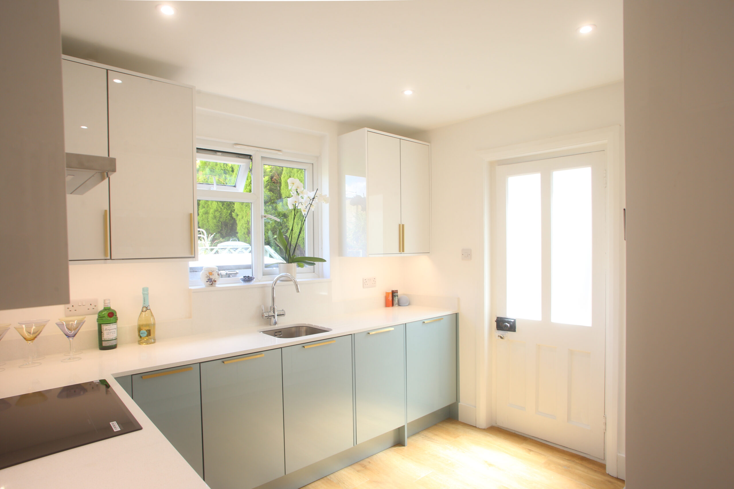 Dover White Quartz worktop run in a bright kitchen with a sink area and smooth white surface finish