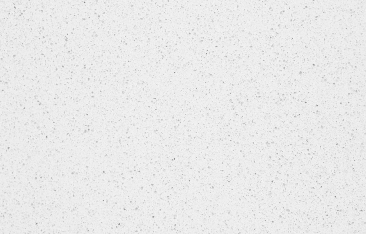 Close-up of a white Quartz surface showing fine speckling and a smooth, uniform finish