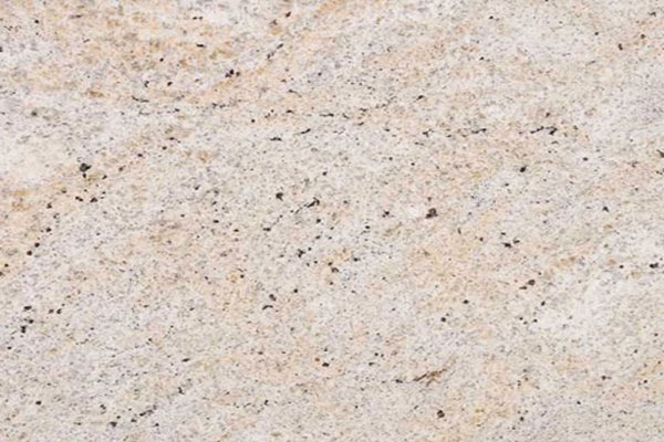 Close up slab photo of Ivory Fantasy Granite showing its light beige base with natural speckling and subtle pattern variation.