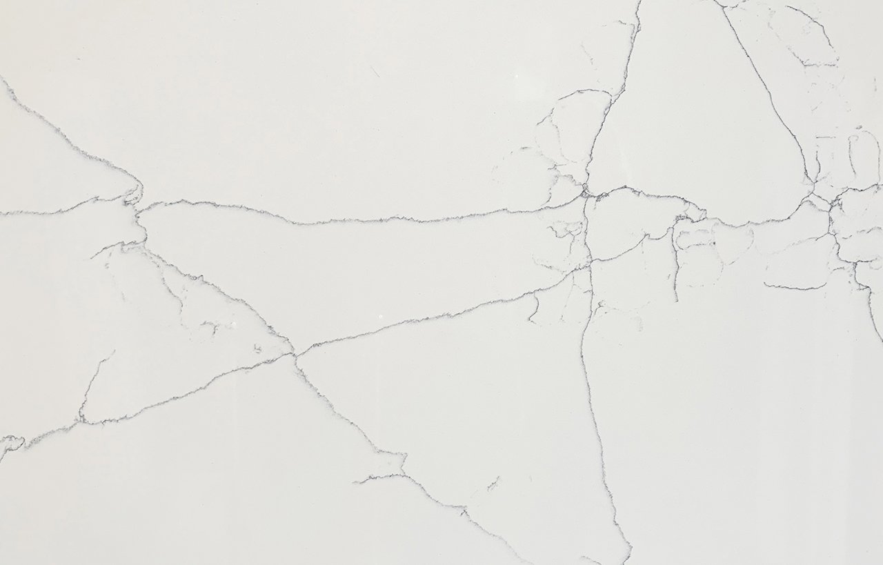 Close-up of White Macaubus Quartz showing fine grey veining across a bright white surface