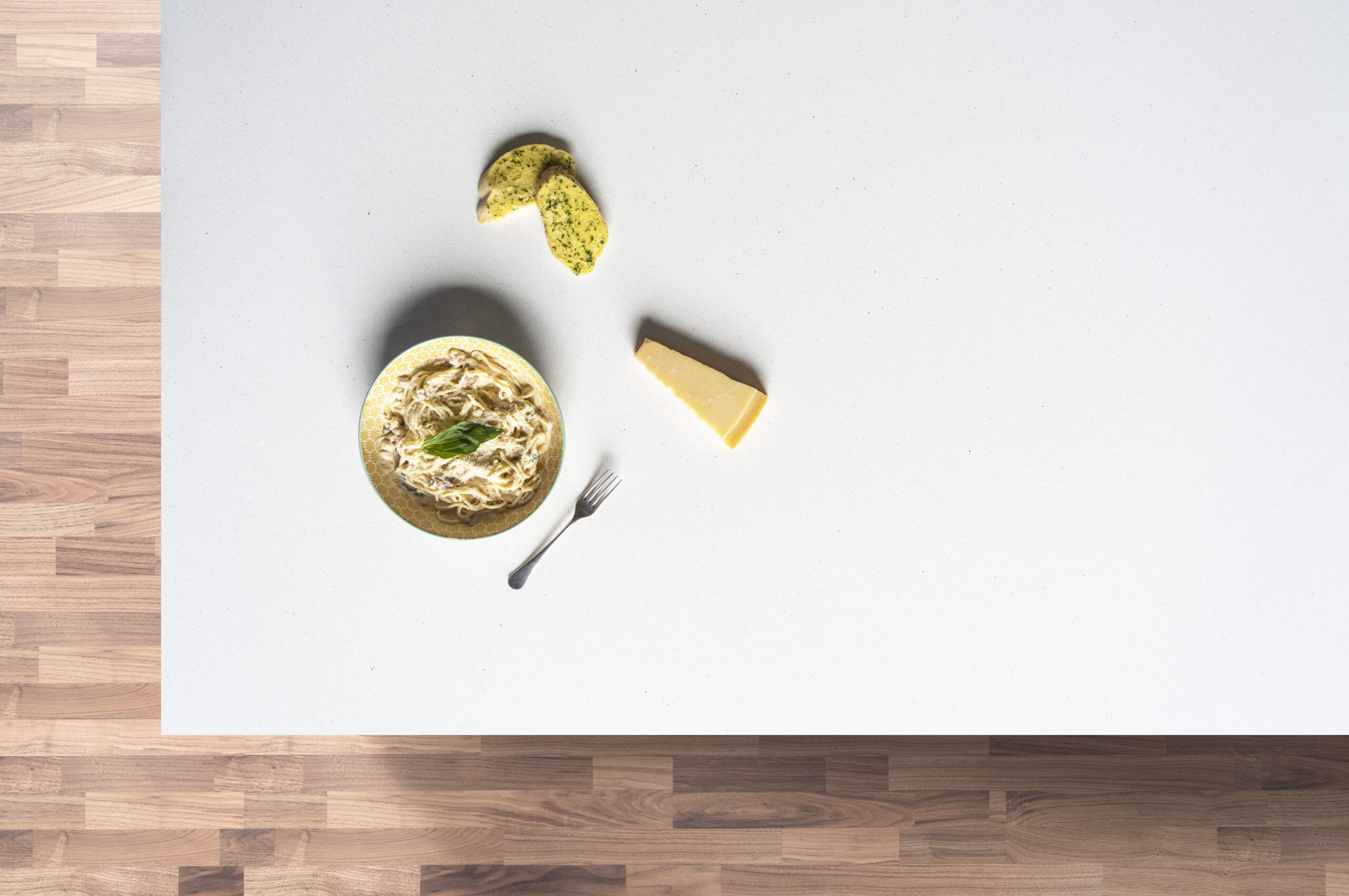 Aspen Shimmer Quartz worktop flat lay with food items on a wooden surface