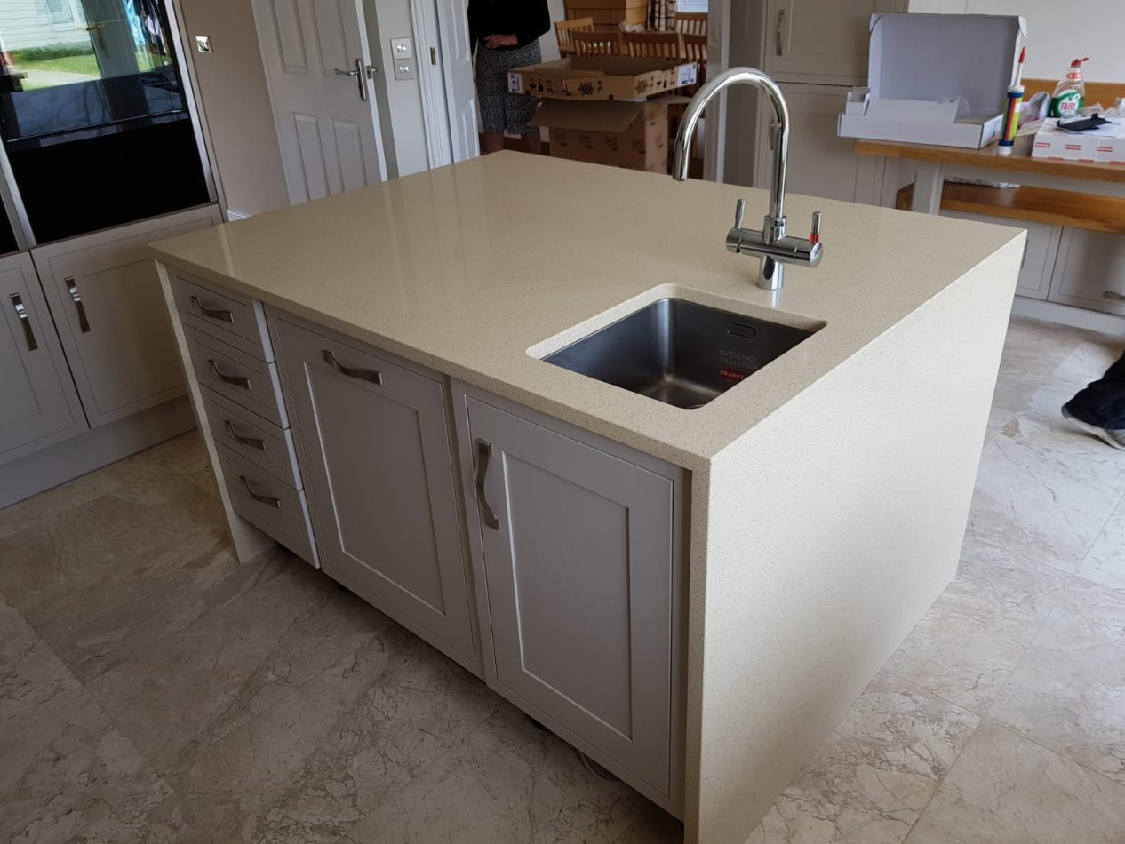 Beige Starlight Quartz island worktop with inset stainless steel sink showing warm beige surface and subtle sparkle