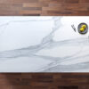 Bianco Lasa Porcelain worktop slab photographed from above, showing soft grey veining on a white background