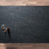 Overhead view of a Blue Pearl Granite worktop showing shimmering flecks across a dark surface, photographed from above with a small styled tray in the corner.