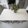 Overhead view of a Classic White Quartz kitchen island showing a smooth bright surface with seating below
