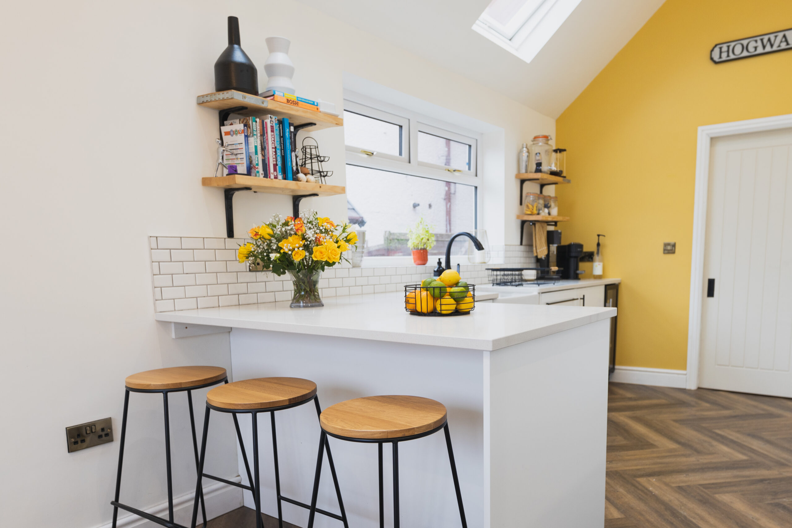 Breakfast bar with Ice White Quartz worktop and seating, showing a smooth white surface finish