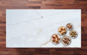 Overhead view of Ethereal Calacatta Quartz worktop showing gold and grey veining on a bright white surface with food dishes