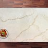 Supreme Calacatta Quartz worktop shown from above with warm gold veining across a bright white marble-effect surface