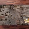 Trilium Porcelain worktop sample on a wooden surface with a small floral detail in the corner