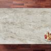 Taga Porcelain worktop slab shown from above with a warm light stone effect surface on a wood background