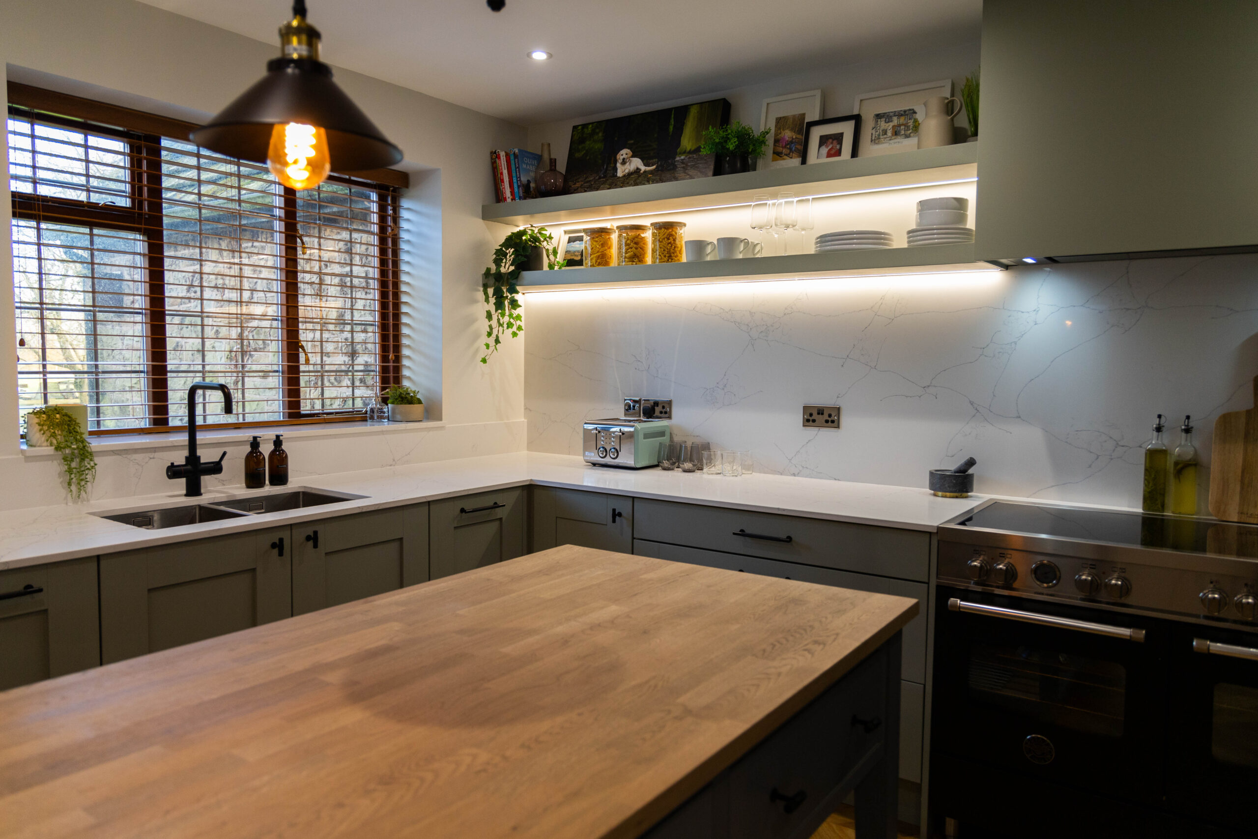 Modern kitchen with White Macaubus Quartz worktops and a large wooden island, showing bright white surfaces with soft veining