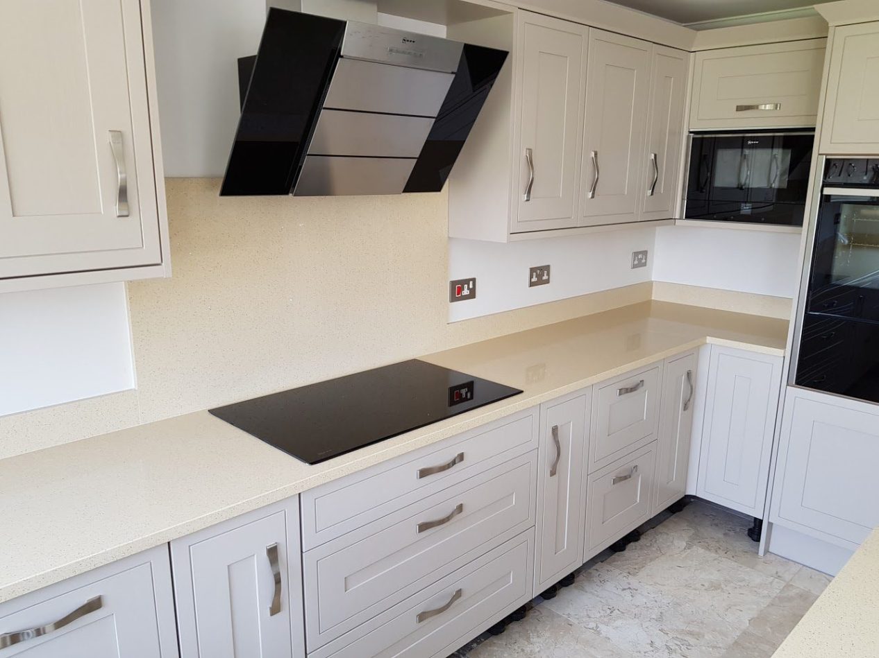 Beige Starlight Quartz worktop run with hob cut-out showing warm beige surface and subtle speckled sparkle