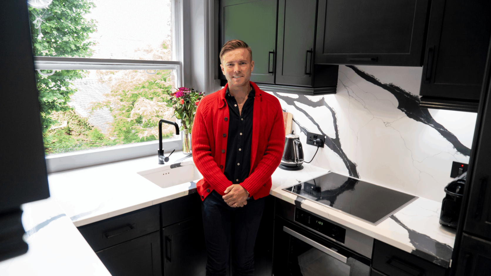 Will testimonial kitchen featuring Black Calacatta Quartz worktops with bold veining and a matching splashback