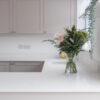 Bluetta Carrara Quartz worktop run with an undermount sink and a smooth bright white surface finish