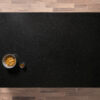 Overhead view of a Nero Cosmos Granite worktop showing a deep black surface with subtle sparkling flecks, photographed from above with a small styled tray in the corner.