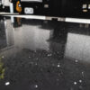Close-up of Black Starlight Quartz worktop showing reflective sparkle flecks across a polished black surface