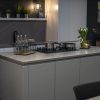Pietra Grey Quartz worktops on a modern island with dark grey stone-effect surface and fine white veining