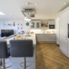 Aspen Shimmer Quartz worktops in a bright open plan kitchen with bar seating