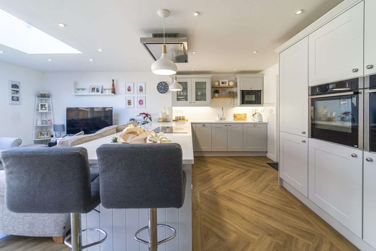 Aspen Shimmer Quartz worktops in a bright open plan kitchen with bar seating