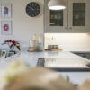 Aspen Shimmer Quartz worktops in a bright kitchen with modern decor and wall shelves