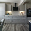 Modern kitchen fitted with White Starlight Quartz worktops and light grey cabinetry