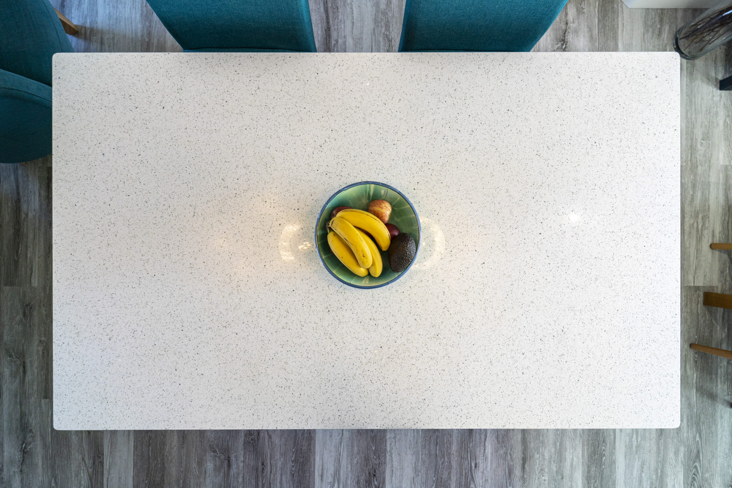 White Starlight Quartz worktop surface styled with fruit in a bright kitchen setting