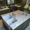 Gold Calacatta kitchen island with sink, brass tap and warm veining
