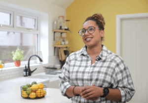Alanna in her kitchen with Ice White Quartz worktops visible in the background near the sink and island