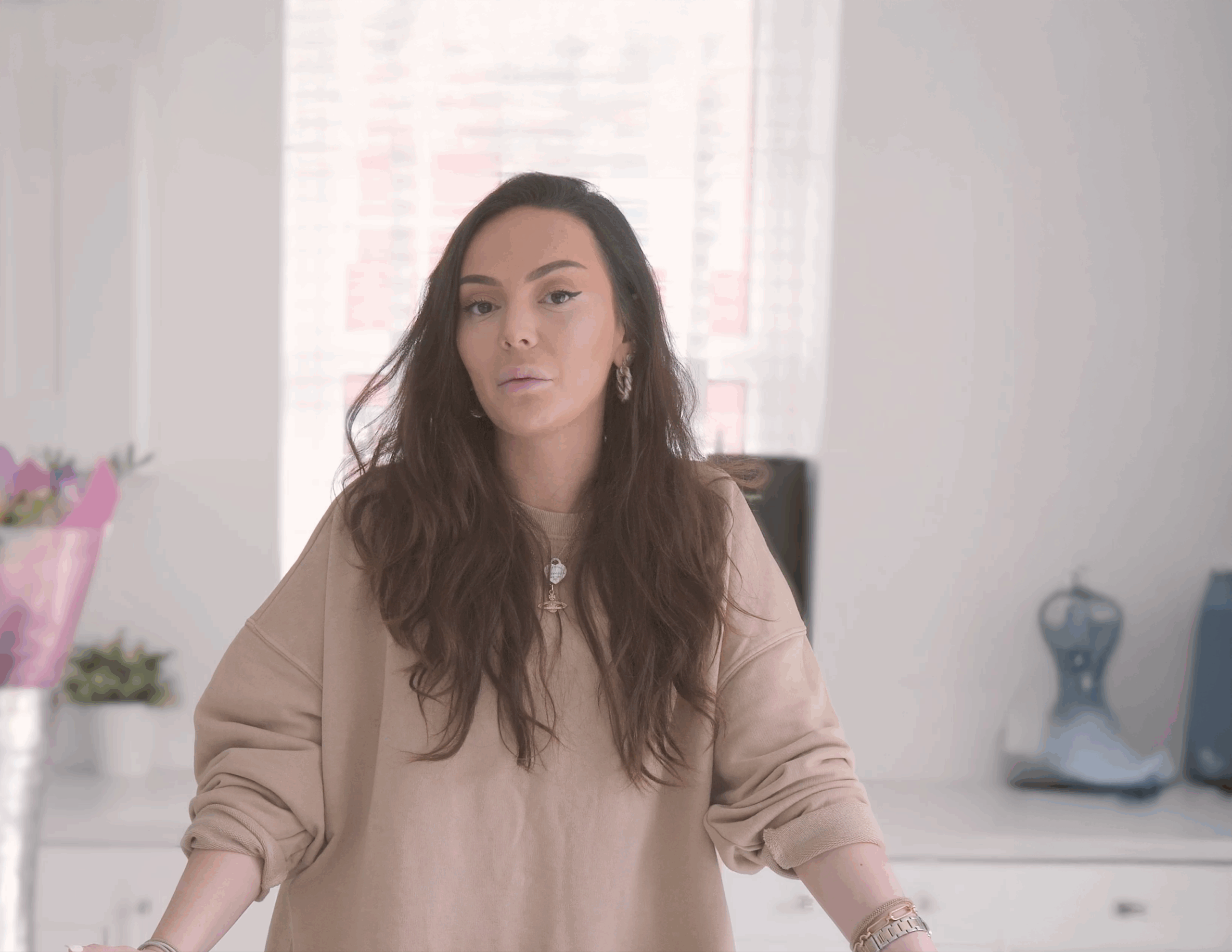 Tania giving a testimonial in her kitchen featuring Statuario Bianco Porcelain worktops installed by Mayfair Worktops