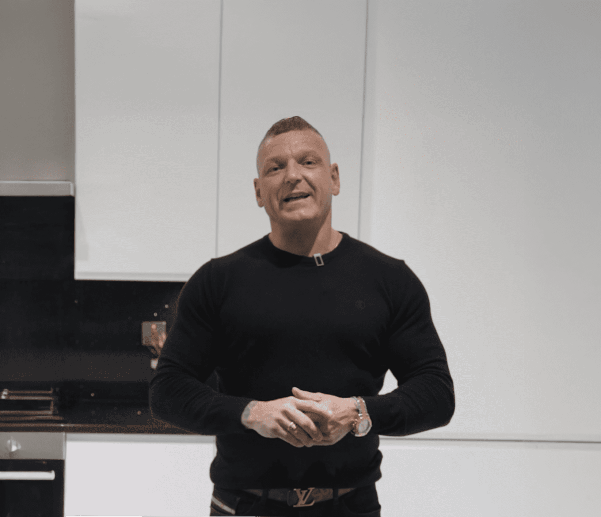 Dean customer testimonial image in a kitchen with Black Starlight Quartz worktop visible in the foreground