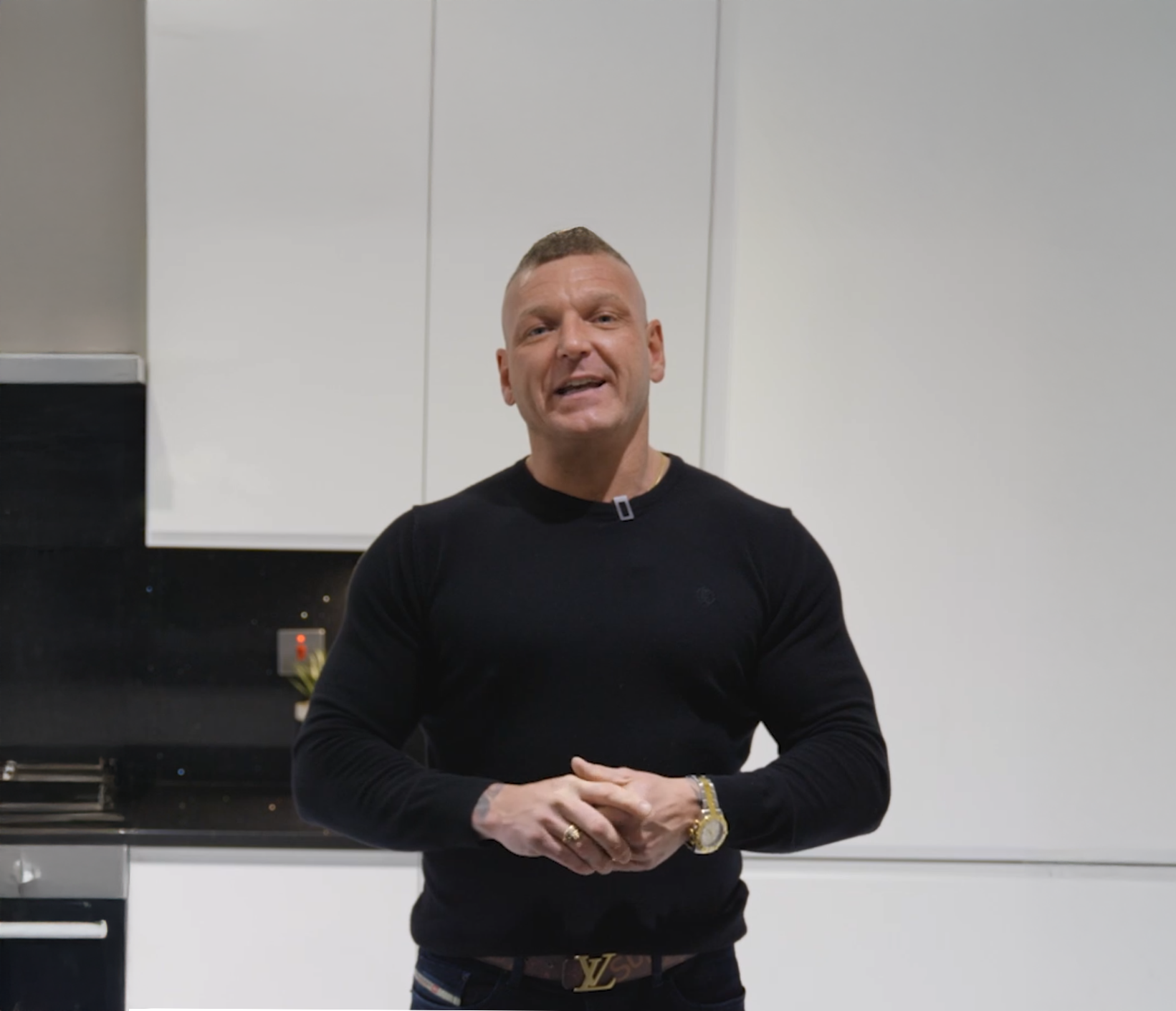 Dean customer testimonial image in a kitchen with Black Starlight Quartz worktop visible in the foreground