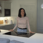 Lizzie giving a testimonial in her kitchen featuring Aspen Shimmer Quartz worktops