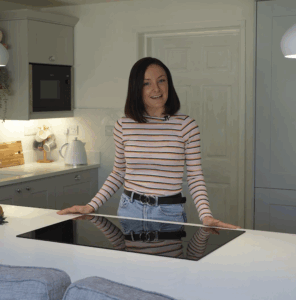 Lizzie giving a testimonial in her kitchen featuring Aspen Shimmer Quartz worktops