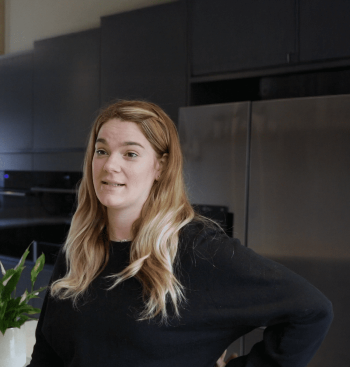Megan testimonial kitchen featuring Grey Drift Quartz worktops in a modern space with dark cabinetry