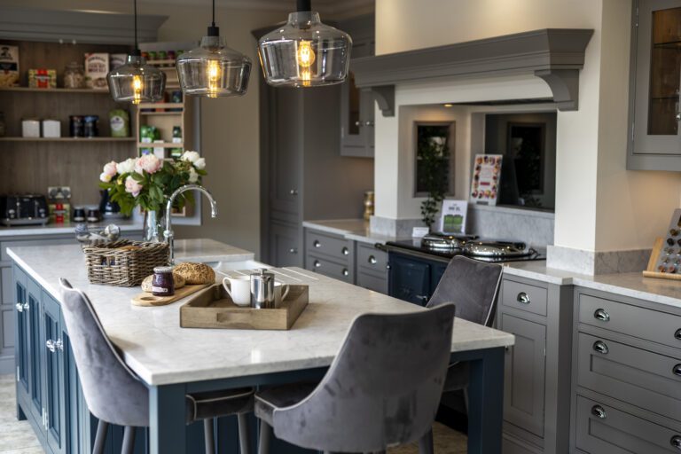 Super White Quartz island worktop in an open-plan kitchen with breakfast bar seating and a light marble-effect pattern