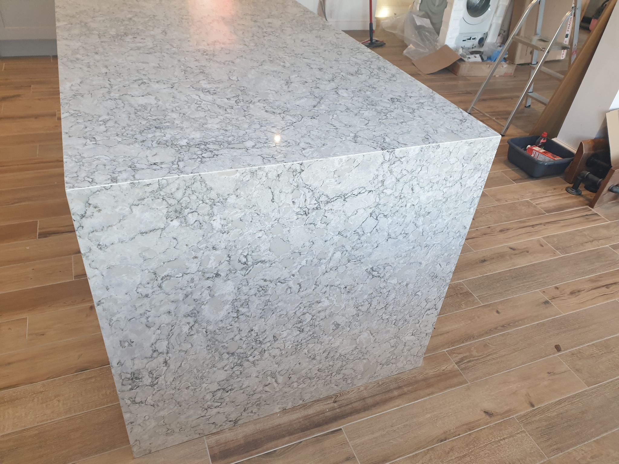 Berwyn Drift Quartz island with a waterfall end panel, showing grey marbled veining across the surface