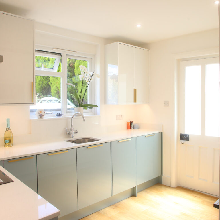 Dover White Quartz worktop run in a bright kitchen with a sink area and smooth white surface finish