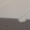 Close-up of Dover White Quartz worktop edge showing a smooth finish and fine speckled texture