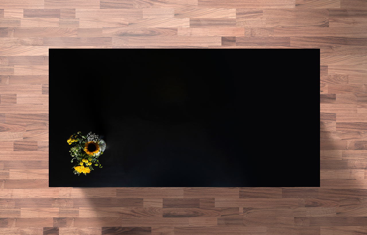 Magma Black Porcelain worktop slab shown from above with a deep black surface on a wood background