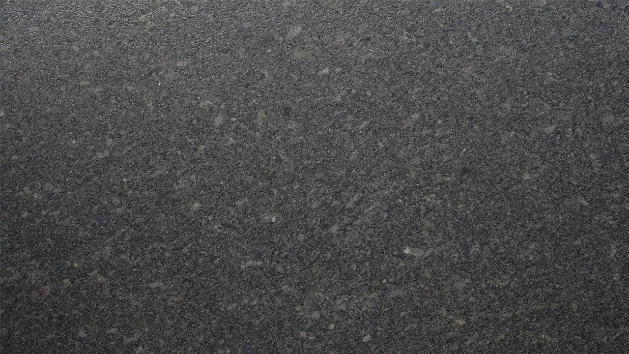 Close up slab photo of Steel Grey leather Granite showing fine speckling and a subtle textured finish across the dark grey surface.