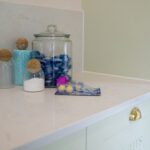 Carrara Quartz worktop with storage jars and accessories in a modern utility room