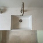 Carrara Quartz worktop with succulent arrangement beside the sink in a laundry room