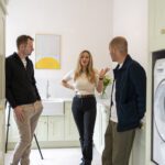 Customers talking together in finished laundry room with Carrara Quartz worktops