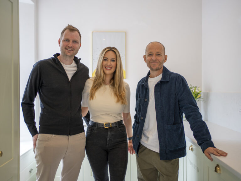 Customers standing together in completed laundry room featuring Carrara Quartz worktops