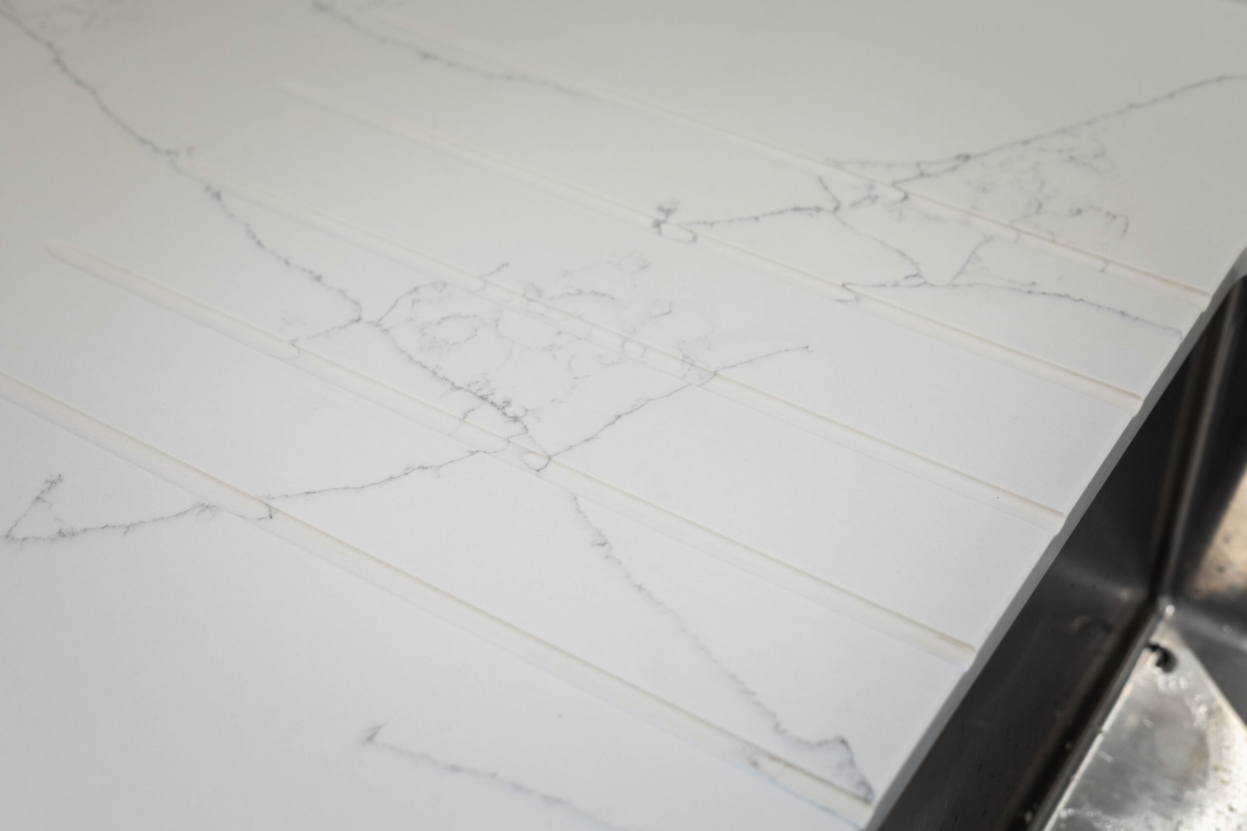 White Macaubus Quartz worktop close-up showing delicate grey veining and a clean white finish