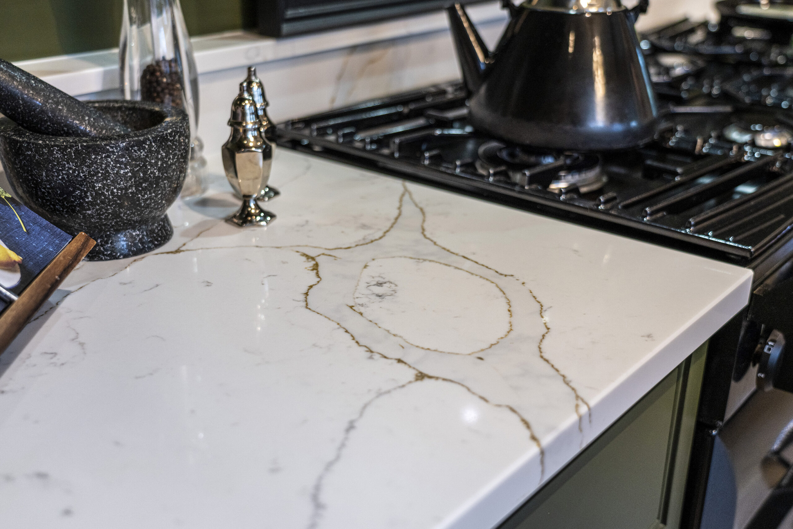 Gold Calacatta worktop with hob cut out displaying bold warm veining