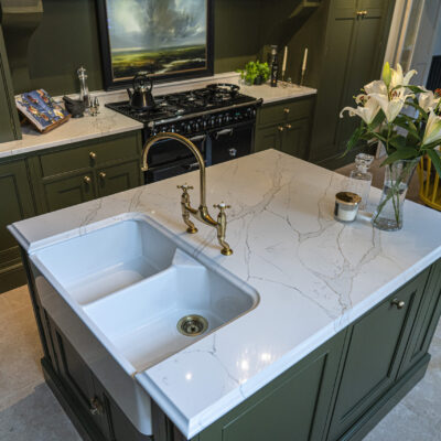Gold Calacatta kitchen island with sink, brass tap and warm veining